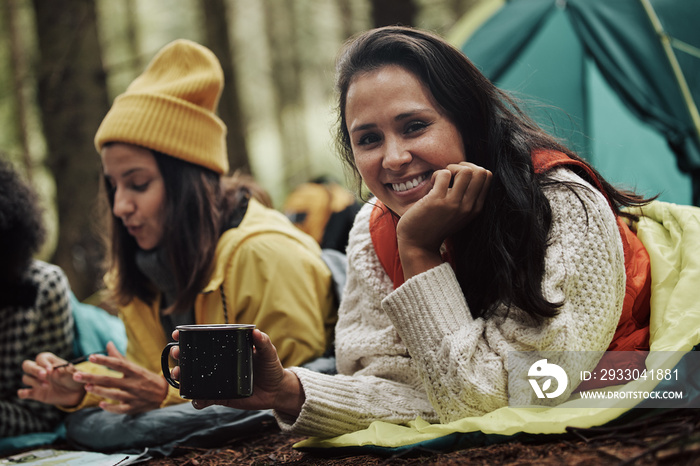 Smiling woman camping with some friends