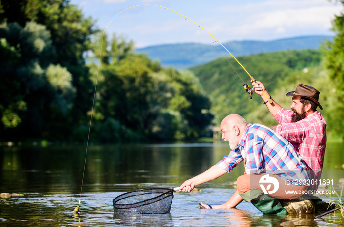 Big game fishing. fly fish hobby of men. retirement fishery. happy fishermen friendship. Two male friends fishing together. Catching and fishing. retired dad and mature bearded son