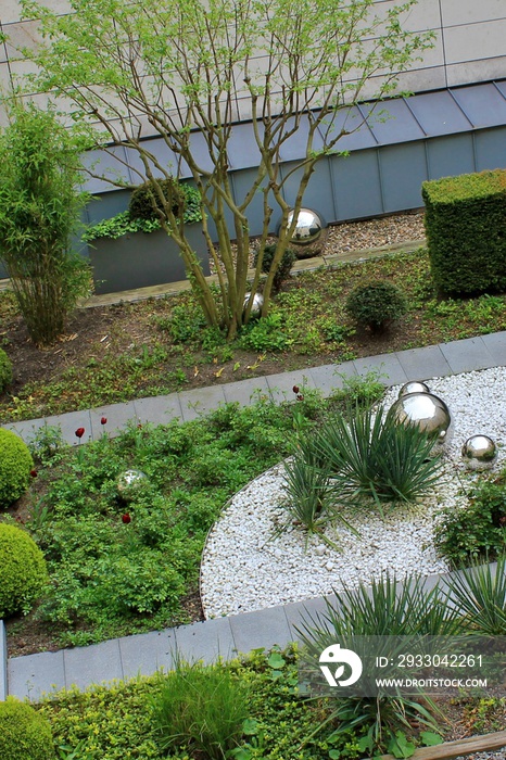 Roof garden with green plants and decorated with silver balls; which balls