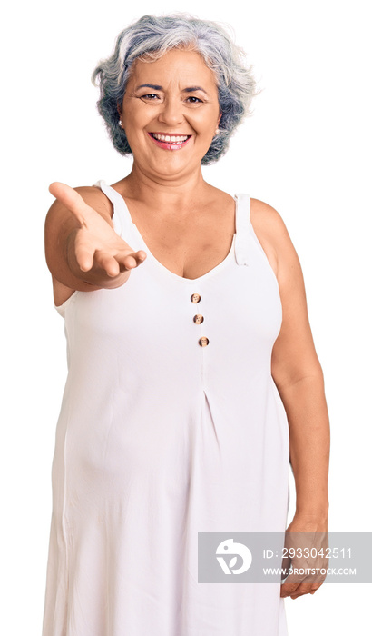 Senior woman with gray hair wearing casual clothes smiling friendly offering handshake as greeting and welcoming. successful business.