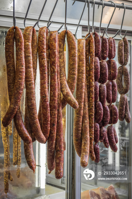 Various home made sausages hanging in the butcher shop