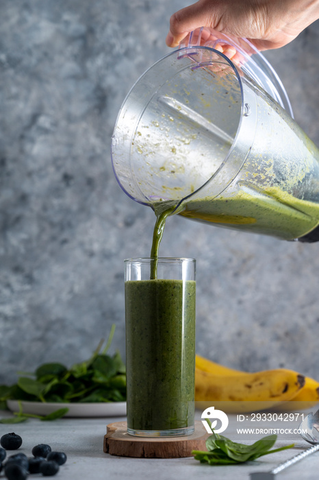 Green spinach, banana and blueberry smoothie. Healthy vegan juice drink.