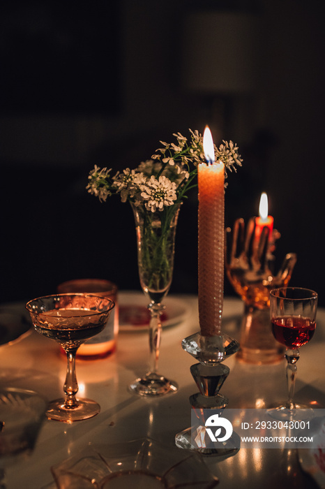 evening tabletop with taper candles, cocktails, wine, flowers