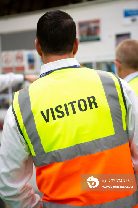 Visitors wearing PPE in a manufactoring plant