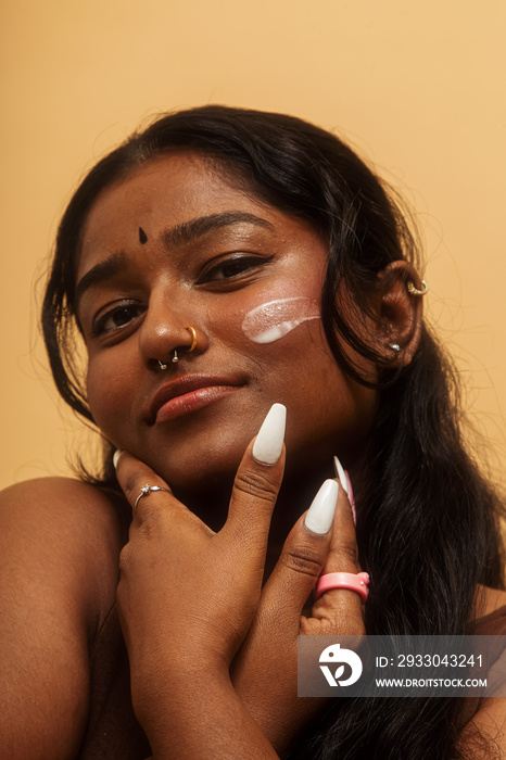 South Asian female solo lifestyle studio portrait skin care shot