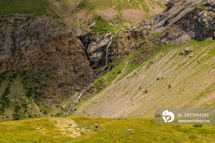 A young female hiker walking towards Salto de Tendendera waterfall in Ripera Valley, Huesca