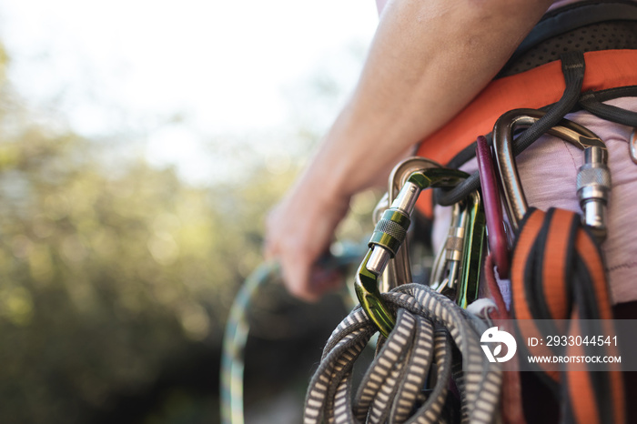 Carabiners and quickdraws on the climber’s harness