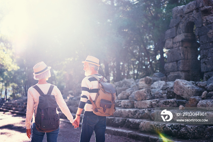 Travel and tourism. Senior family couple walking together on ancient sightseeing.