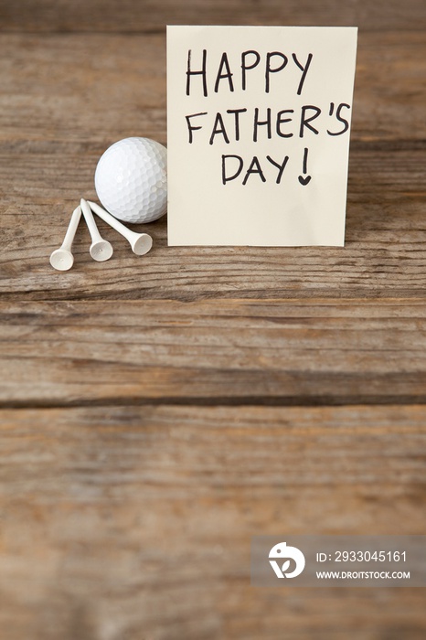 Fathers day greeting card and golf ball on table