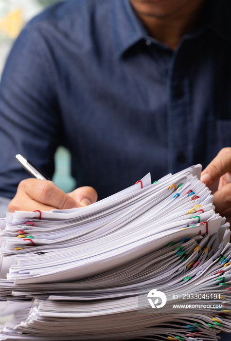 Vertical male office workers holding and writing documents