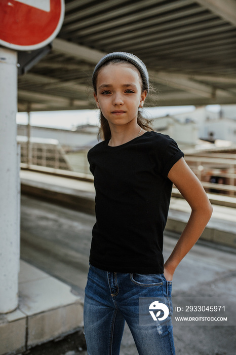 Girl kid wearing black blank t-shirt. Mock up for print.