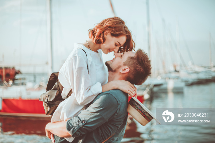 Romantic concept. Young couple in love at sea on a background of yachts club. Youth Lovestory