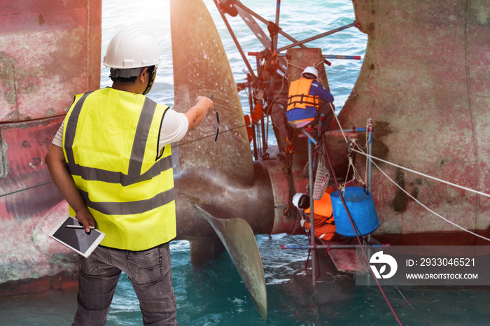 foreman supervisor in charge of repairing and replacement of shaft on propeller of the ship in medsea port terminal, the workers and technician under working safety