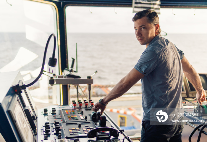 Marine navigational officer during navigational watch on Bridge . Work at sea