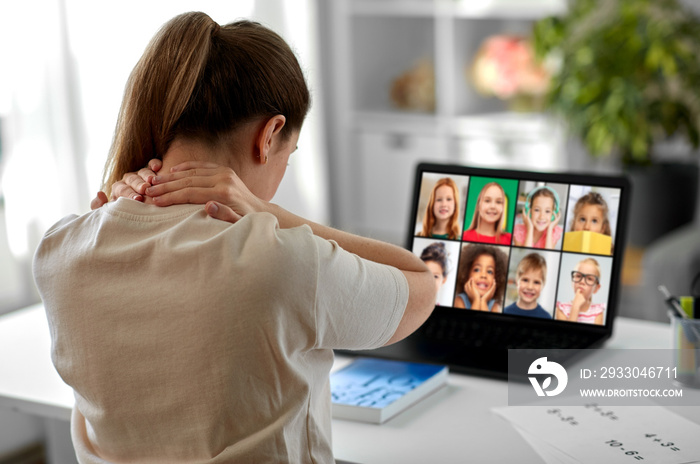 distant education, remote job and health concept - tired female teacher having online class with group of students on laptop computer and touching her aching neck at home office