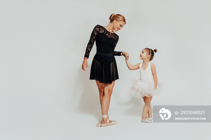 Ballroom dance teacher and little child is dancing in a bright hall dance studio. dance classes.