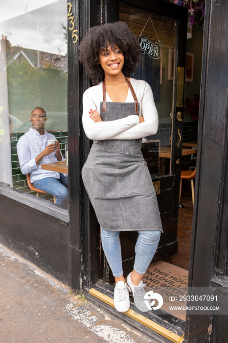 UK, London, Portrait of smiling cafe owner at doorway