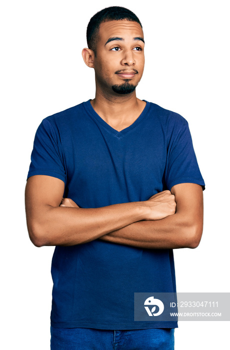 Young african american man with arms crossed gesture smiling looking to the side and staring away thinking.