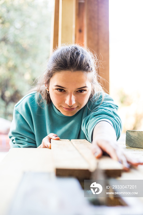 A woman works in a carpentry workshop.