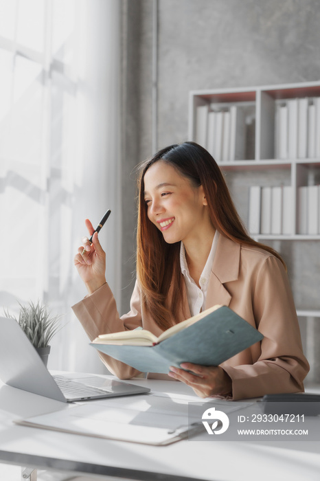 Young asia pretty entrepreneur busy woman in her private office working audit and calculating expense financial annual financial report balance sheet statement, checking inspection tax calculation