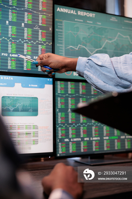 Close up shot of financial advisor pointing out downtrend of market while reviewing real time trading data. Forex stock analyst signaling trade option exit in order to gain full profits.