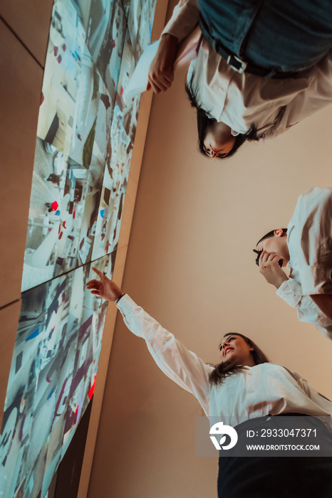 Group of female security operators working in a data system control room Technical Operators Working at workstation with multiple displays, security guards working on multiple monitors in surveillan