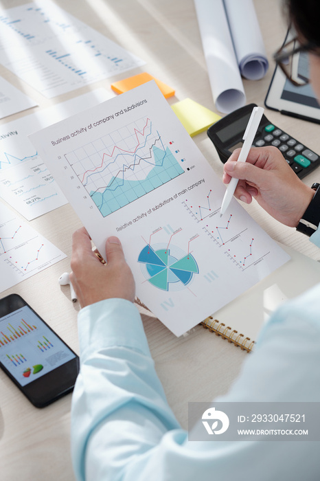 Businessman checking chart showing activity of company and subdivisions