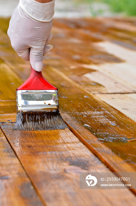 Hand varnishing wooden floor