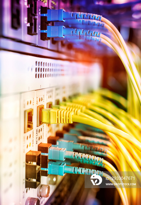 Fiber Optical cables connected to an optic ports and Network cables connected to ethernet ports