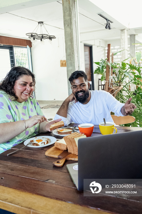 Couple making breakfast together at home in the morning