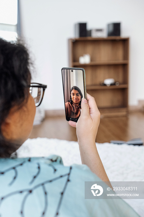 Plus sized female video calling another friend in bed