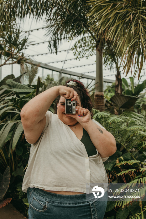 plus size woman takes picture with camera