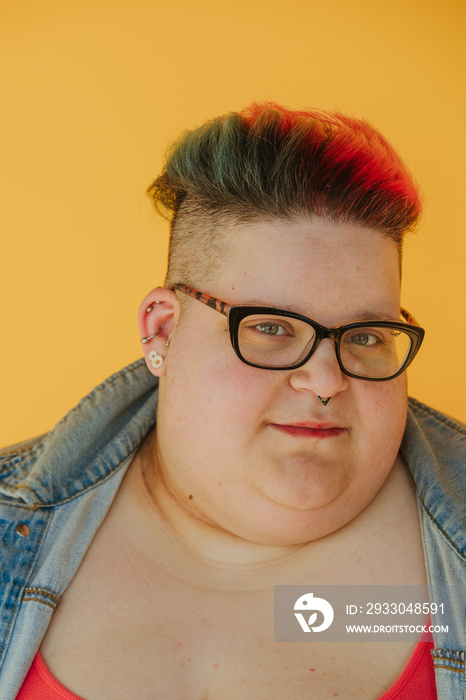 closeup portrait of a plus size woman with rainbow hair and glasses