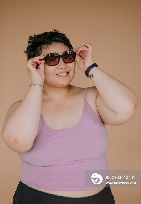 portrait of a plus size filipino woman wearing sunglasses