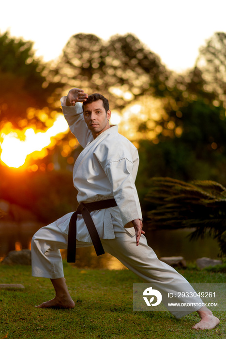 Karate black belt man performing kata outdoors