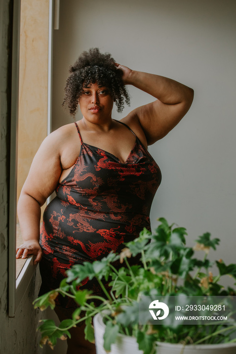 portrait of a plus size afro indigneous person looking at camera