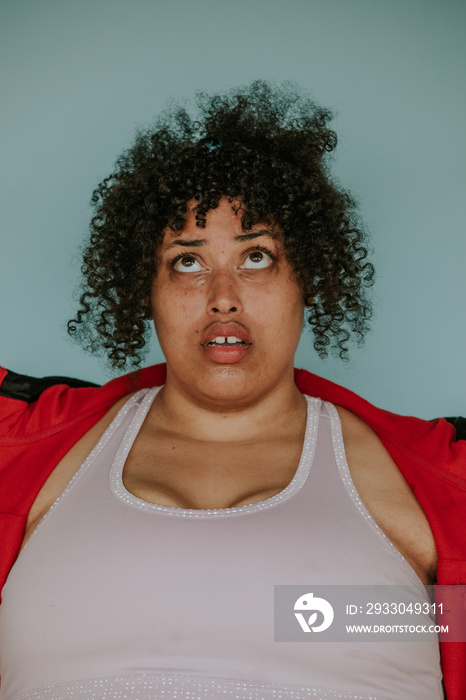 closeup portrait of a plus size afro indigenous person rolling eyes