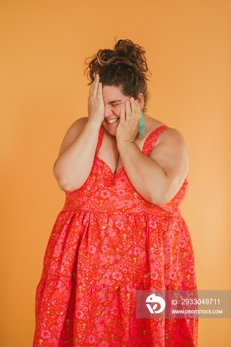 portrait of a plus size person with hands on face