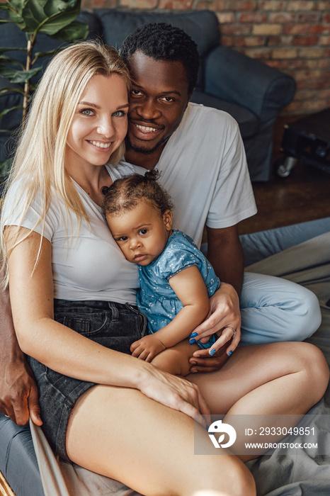 Young interracial family of father mother and their child