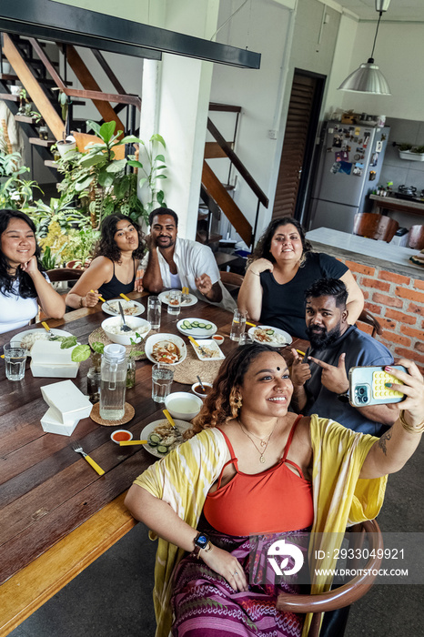 Group of friends sharing a meal together at home