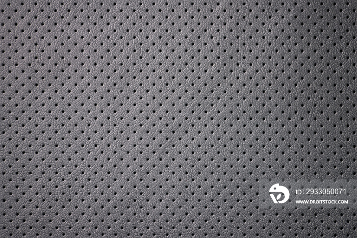 Car perforated leather background. Interior detail. Macro photo.