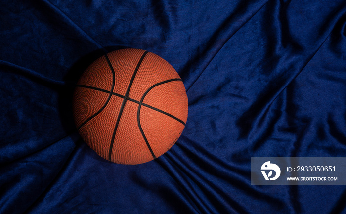 Basket ball top view on silk fabric with copy space