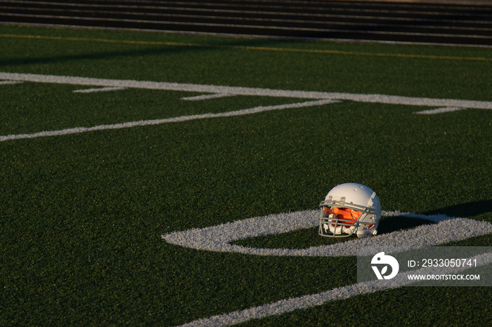 American football helmet on turf