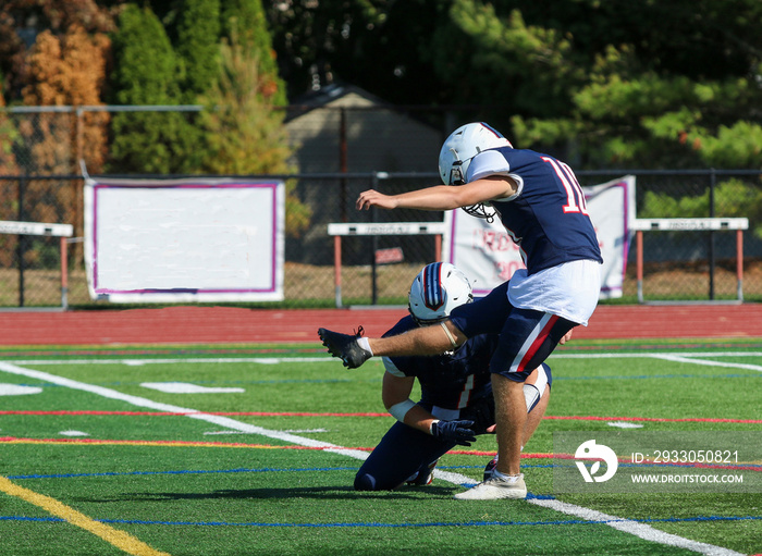 Football kicker kicking a field goal during a game