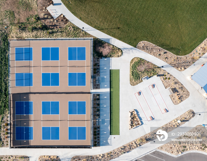 Overhead aerial of multiple pickle ball fields with some landscaping around them.