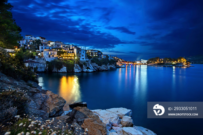 Night view of Plakes, the oldest neighborhood of Skiathos town. To the right, you can see Bourtzi castle.  Skiathos island, Northern Sporades, Greece.