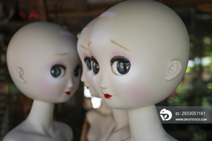 Naked female mannequin dolls in the shop window