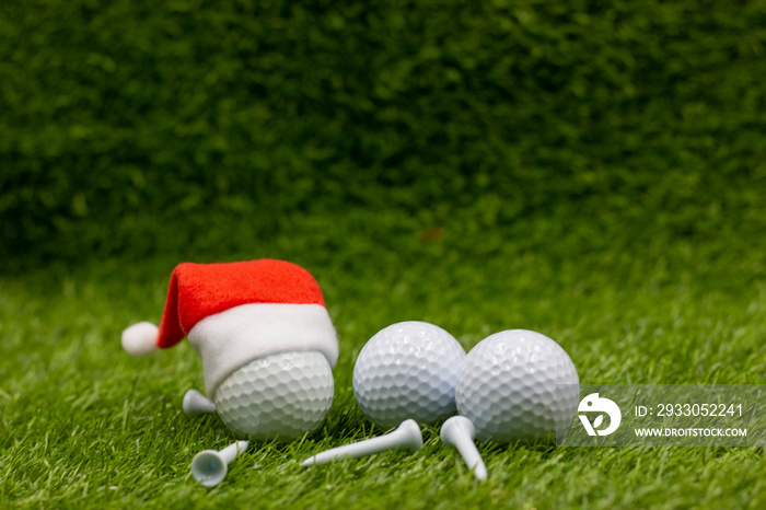 Merry Christmas to golfer with Christmas ornament on green grass