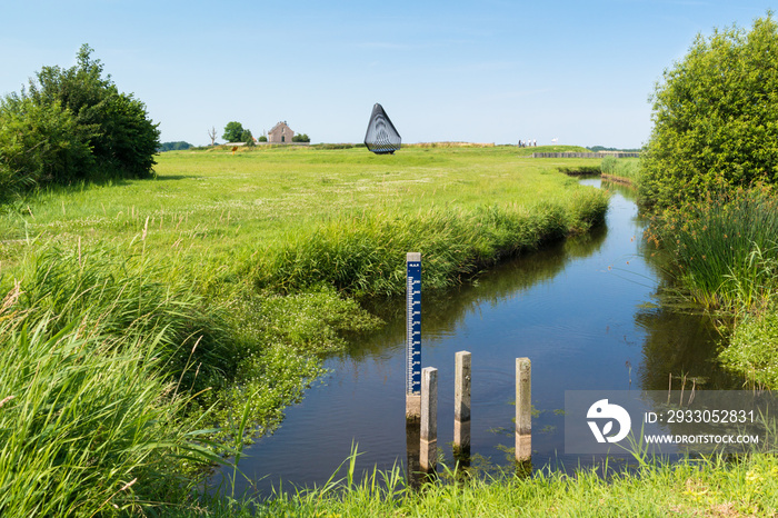 Water level staff gauge in ditch in polder, Netherlands