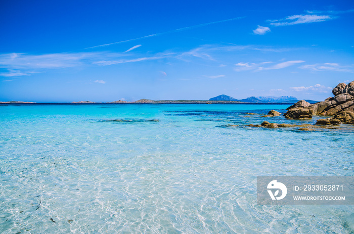 Clear amazing azure coloured sea water with granite rocks in Capriccioli beach, Sardinia, Italy